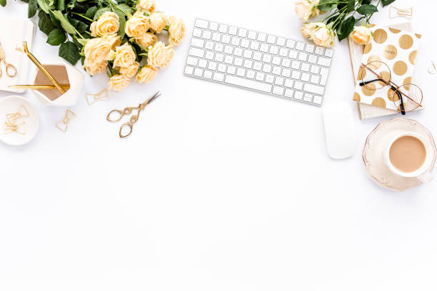 istock Female workspace with computer, roses flowers, golden accessories, diary, laptop, glasses on white background. Flat lay women's office desk. Top view 1270634268