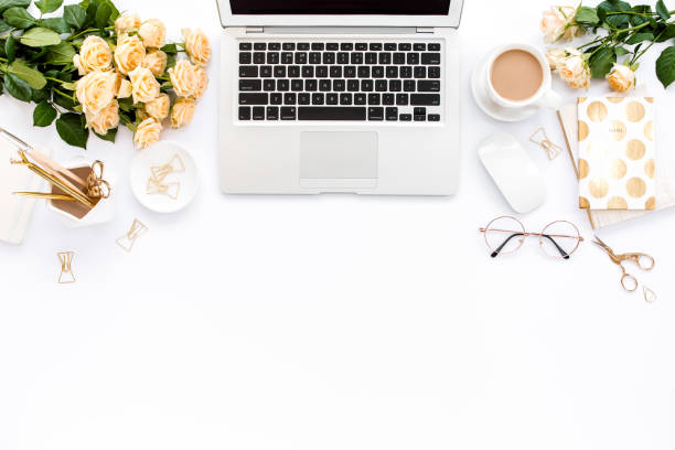 istock Female workspace with laptop, roses flowers, golden accessories, diary, computer, glasses on white background. Flat lay women's office desk. Top view 1270634294