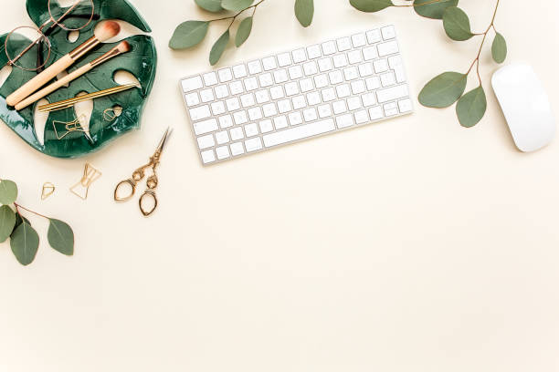 istock Flat lay home office desk. Female workspace with computer, plate sheet monstera, golden accessories, eucalyptus leaves, on beige background. Top view 1270635757