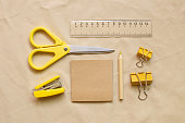Various stationery set. office and school supplies on beige fabric background. top view, copy space