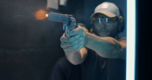 istock Man learning to fire revolver with trainer 1270638131