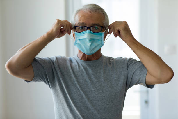 istock Senior man wearing masks at home 1270639690