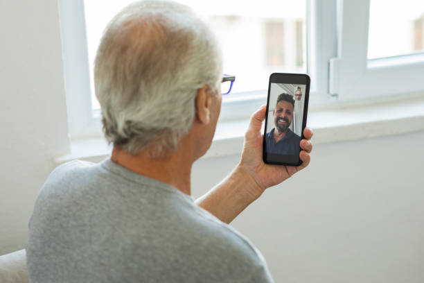 istock Father and son video chatting with phone 1270640335