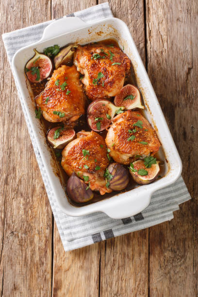 istock Mediterranean menu chicken thighs baked with ripe figs and herbs close-up in a baking dish. vertical top view 1270641108
