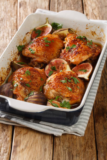 istock Mediterranean menu chicken thighs baked with ripe figs and herbs close-up in a baking dish. vertical 1270641203