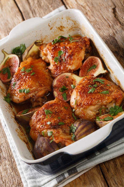 istock Delicious baked balsamic chicken thighs with figs and herbs close-up in a baking dish. vertical 1270641229