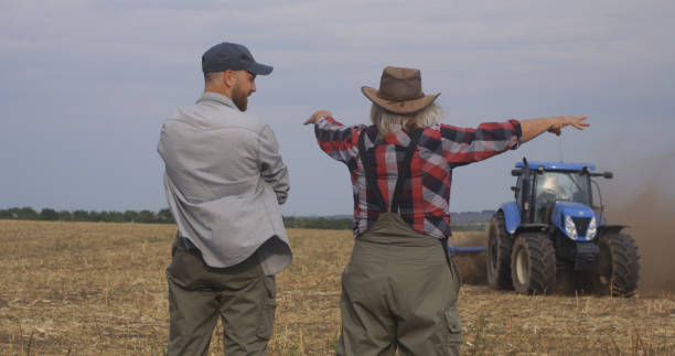 istock Glad elderly farmer showing soil fertility to successor 1270641501