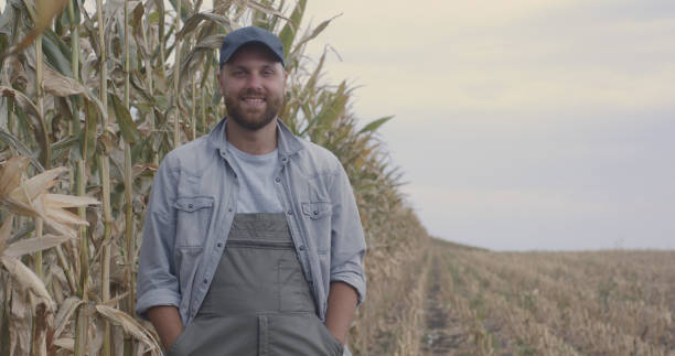 istock Happy farmers examining corn in field 1270641558