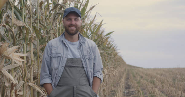 istock Happy farmers examining corn in field 1270641585