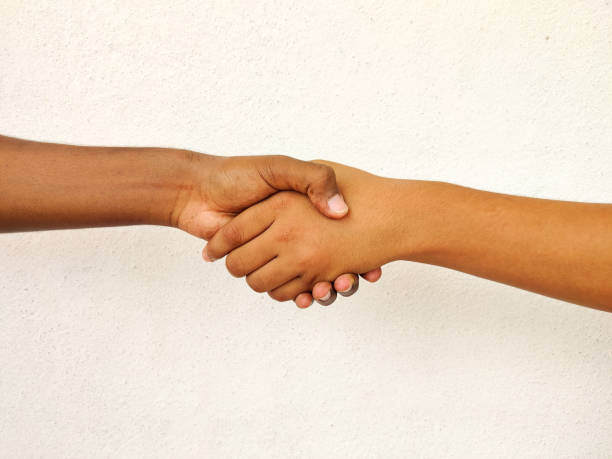 istock Two south Indian men shaking hands isolated on white background. Business concept 1270642030