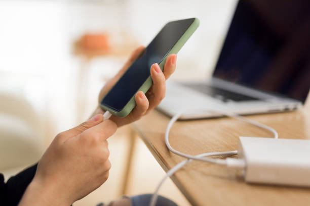 istock Woman charging smart phone with power bank. 1270642818