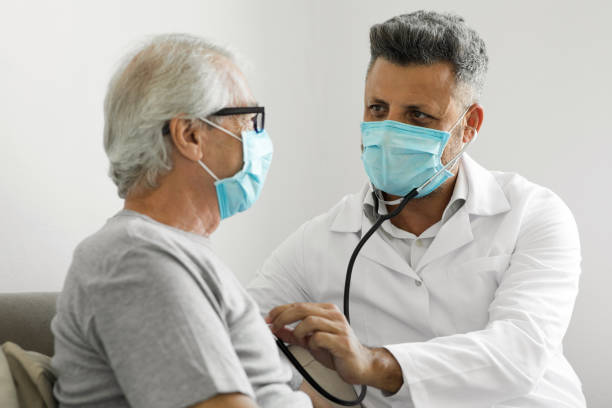 Health visitor and a senior man during home visit Health visitor and a senior man during home visit electrocardiogram diagnostics stock pictures, royalty-free photos & images