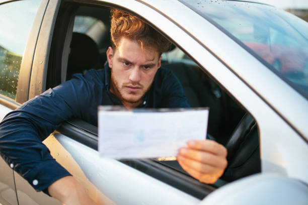 istock Young man can't believe he got parking ticket 1270643173
