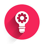 istock White Light bulb and gear icon isolated with long shadow. Innovation concept. Business idea. Red circle button. Vector Illustration 1270643340