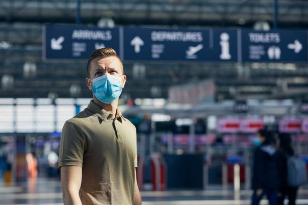 istock Man wearing face mask at airport 1270645657