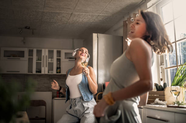 istock Two girl friends playing guitar home 1270645833