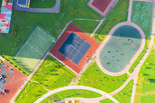 Top view, bird eye view of residential area with sports grounds courts