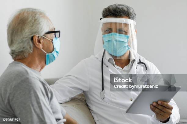 Doctor Visiting His Patient At His Home Stock Photo - Download Image Now - Protective Face Mask, Patient, Coronavirus