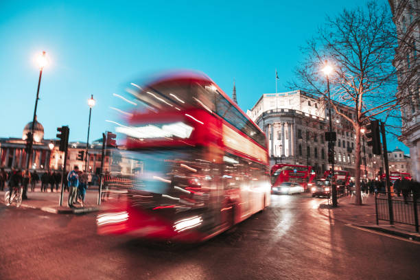 istock Traffic in London, typical red double decker bus passing fast 1270654554