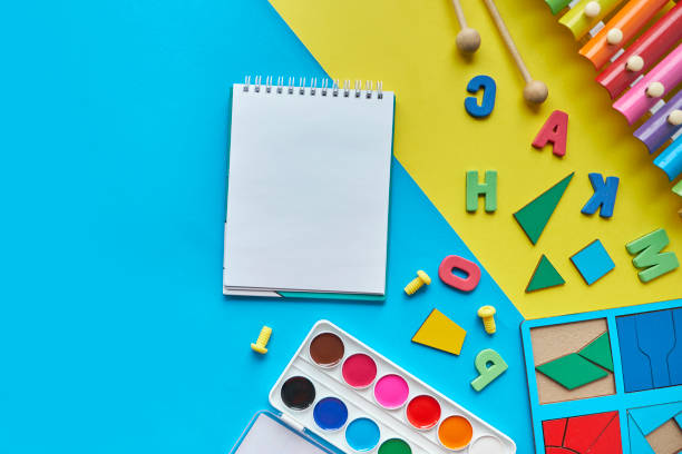 istock top view background with different subjects for lessons with children. creativity, harmonious growing up of a child. and an open notebook, space for text 1270654602