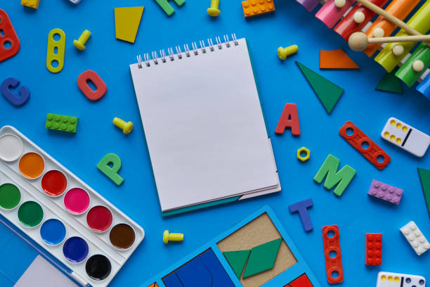 istock top view background with different subjects for lessons with children. creativity, harmonious growing up of a child. and an open notebook, space for text 1270654611