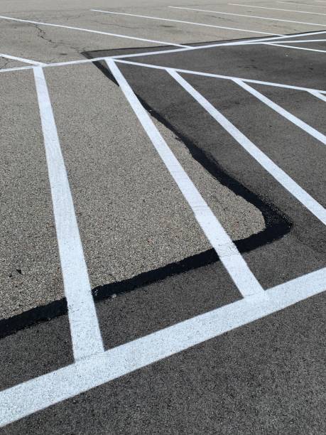 istock White Lines on Patched Asphalt Parking Lot 1270656556