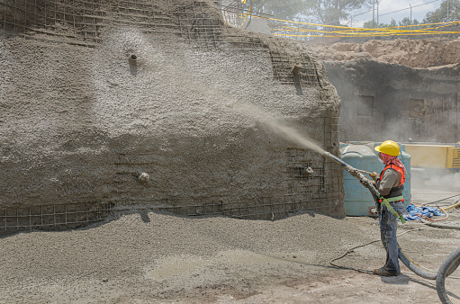Cement applied with high pressure to create masonry walls