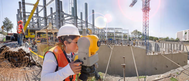 Topographical survey engineer in a building project Panoramic view of a huge construction site theodolite photos stock pictures, royalty-free photos & images