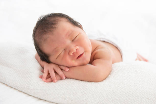 istock Asian newborn baby sleeping in white blanket 1270660541