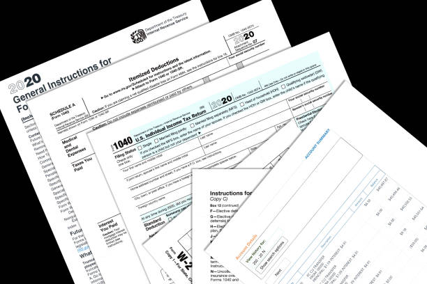 2020 IRS tax forms and imitation account papers on a desktop. 2020 IRS tax forms and imitation personal papers on a desktop. 1040 tax form photos stock pictures, royalty-free photos & images