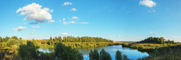 istock Sunny rural landscape with lake and farm fields 1270665778