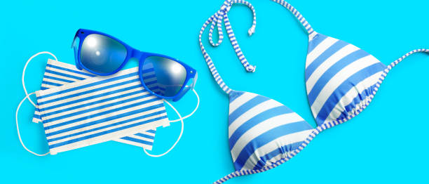 istock Sunglasses with Corona virus mask and bikini 1270666630