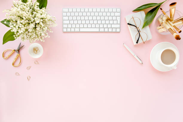 istock Office table desk with computer, lilac, clipboard. magazines. Top view Flat lay. Home office workspace. Women's fashion accessories on pink background 1270669809