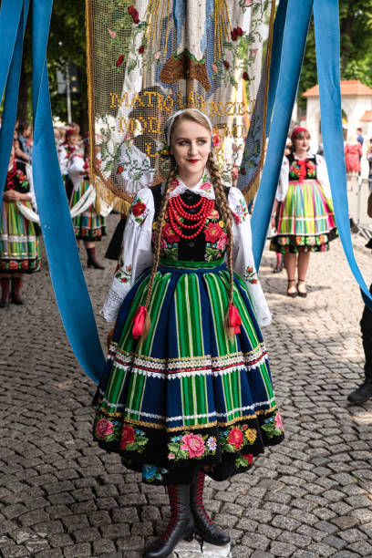 женщина, одетая в польский национальный народный костюм из ловичской области во время процессии корпус-кристи - lowicz стоковые фото и изображения