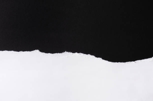 istock White paper with torn edges isolated with black colored paper background inside. Good paper texture 1270671338
