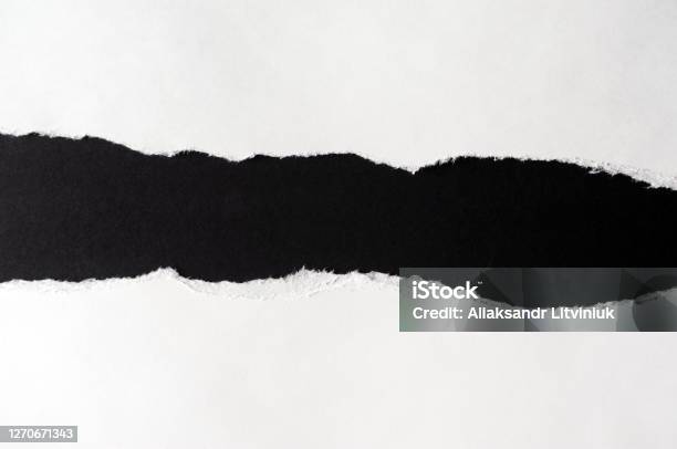 White Paper With Torn Edges Isolated With Black Colored Paper Background Inside Good Paper Texture Stock Photo - Download Image Now