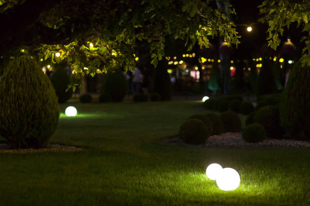 istock illumination backyard light garden with electric ground lantern with round diffuser lamp with garland of light bulb on tree branch, festive party decor landscaping with illuminate night scene, nobody. 1270672732