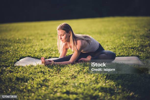 Sporty Beautiful Young Woman Doing Hamstring Stretch Exercise Stock Photo - Download Image Now
