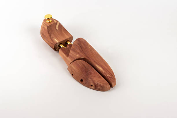 Wooden shoe lasts on a white background. Selective focus. Close-up. Shoe wooden mold holders on a white background. Selective focus. Close-up. shoe mold stock pictures, royalty-free photos & images
