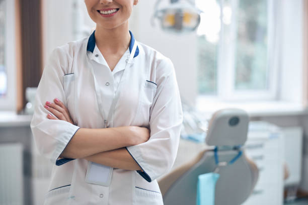 istock Merry beautiful dentist enjoying work in office 1270675579