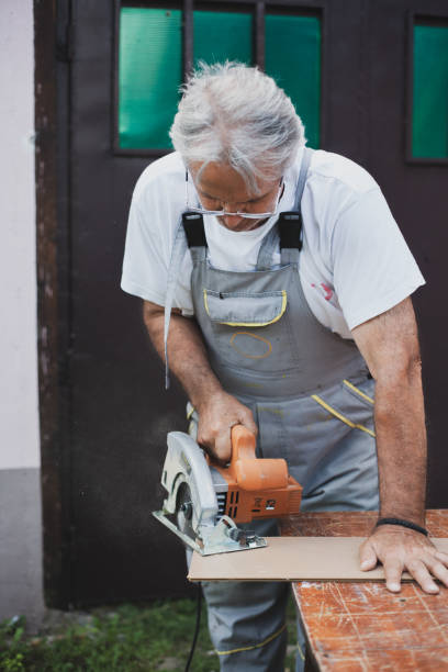 istock Senior carpenter working in his back yard during isolation 1270677929