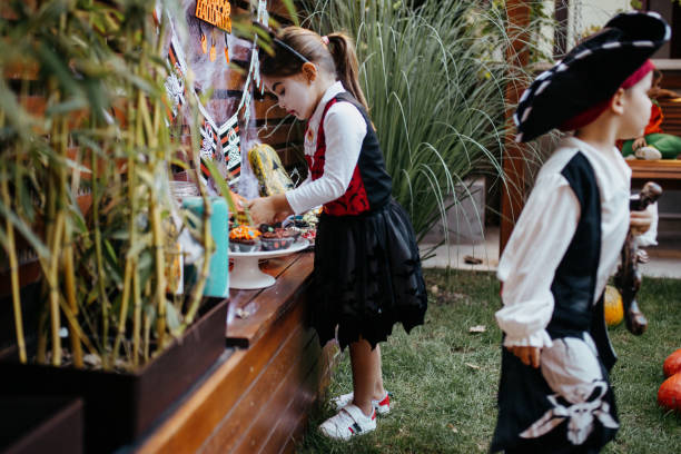 istock Kids eating candy at Halloween party in their backyard 1270678261