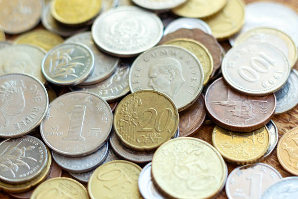 istock coins old rusty brass euro Seychelles Bulgaria China Germany pile pack heap stack on a wooden background finance economy investment savings concept mock up selective focus close up 1270678848