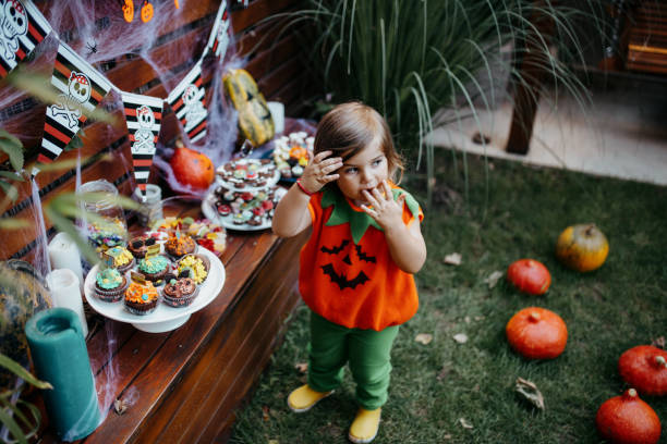 istock Kids eating candy at Halloween party in their backyard 1270679051