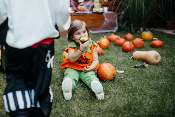 istock Kids eating candy at Halloween party in their backyard 1270679087