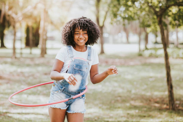istock child playing hula hoop in the park 1270679227