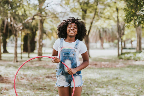 istock child playing hula hoop in the park 1270679231