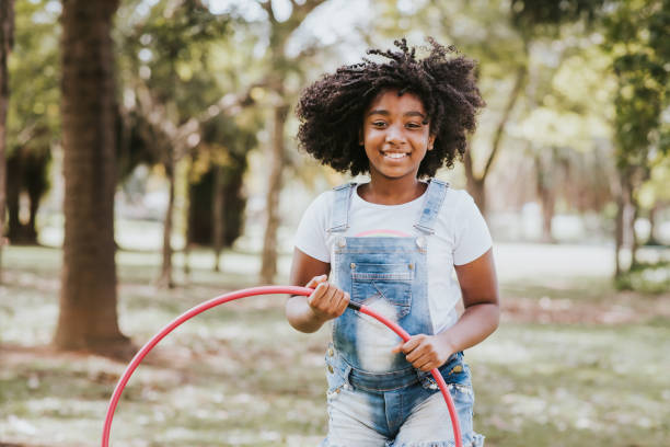 istock child playing hula hoop in the park 1270679237