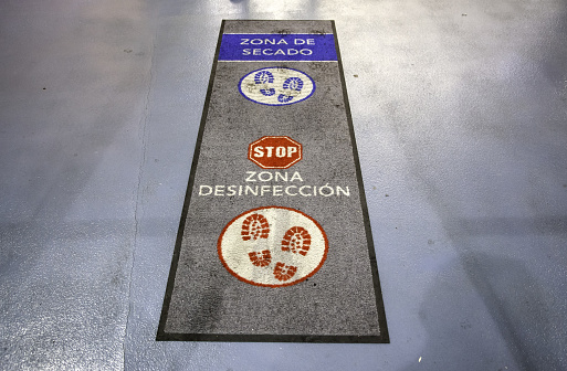 Covid disinfection carpet at the entrance to the shop, cleaning and viruses