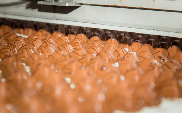 istock Sweets factory. Sweets production process. Conveyor belt with sweets on it. 1270681896